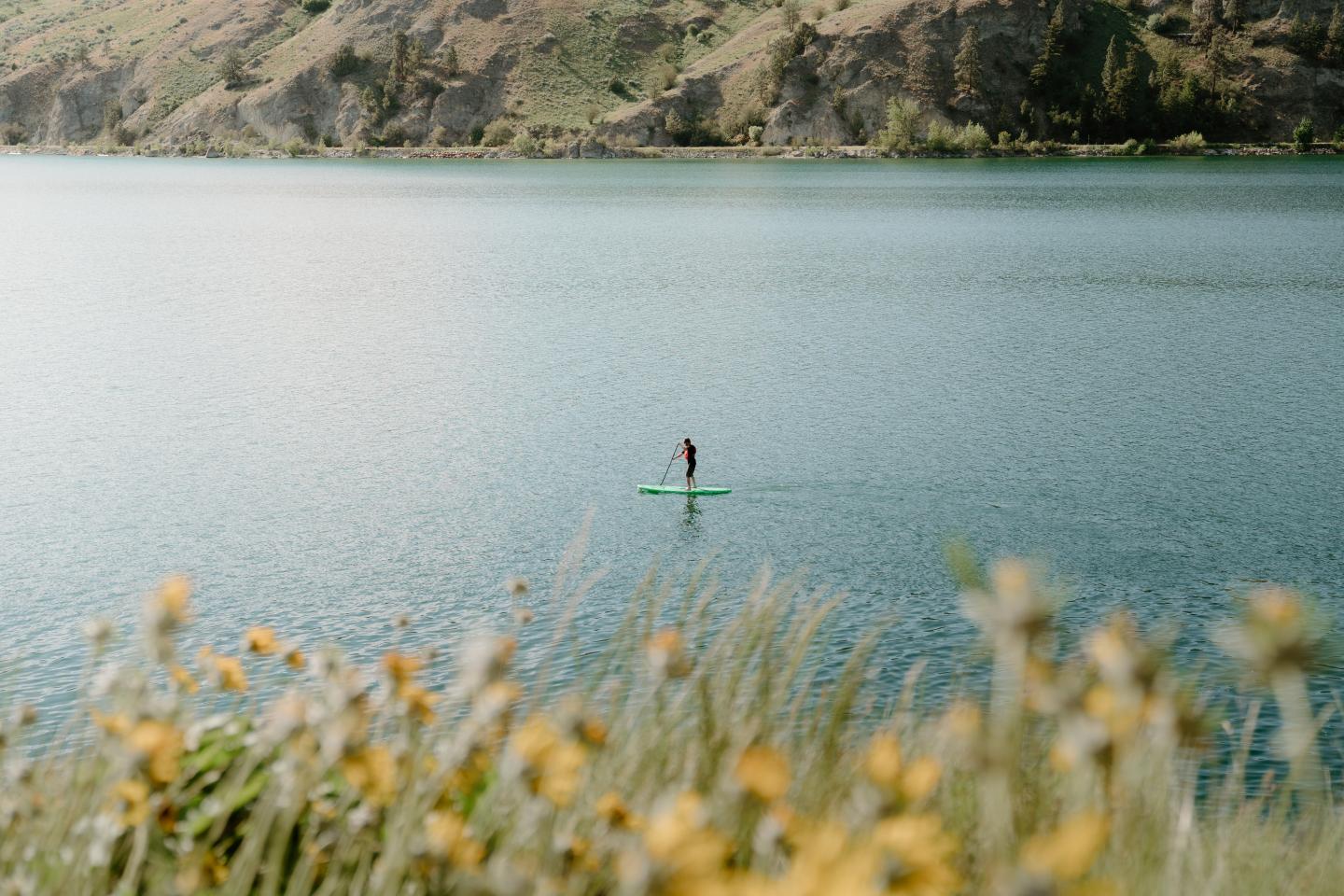 A person paddle boarding on a lake