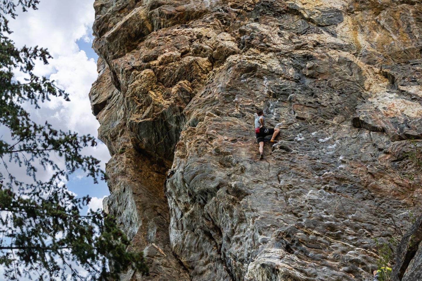 person outdoor rock climbing