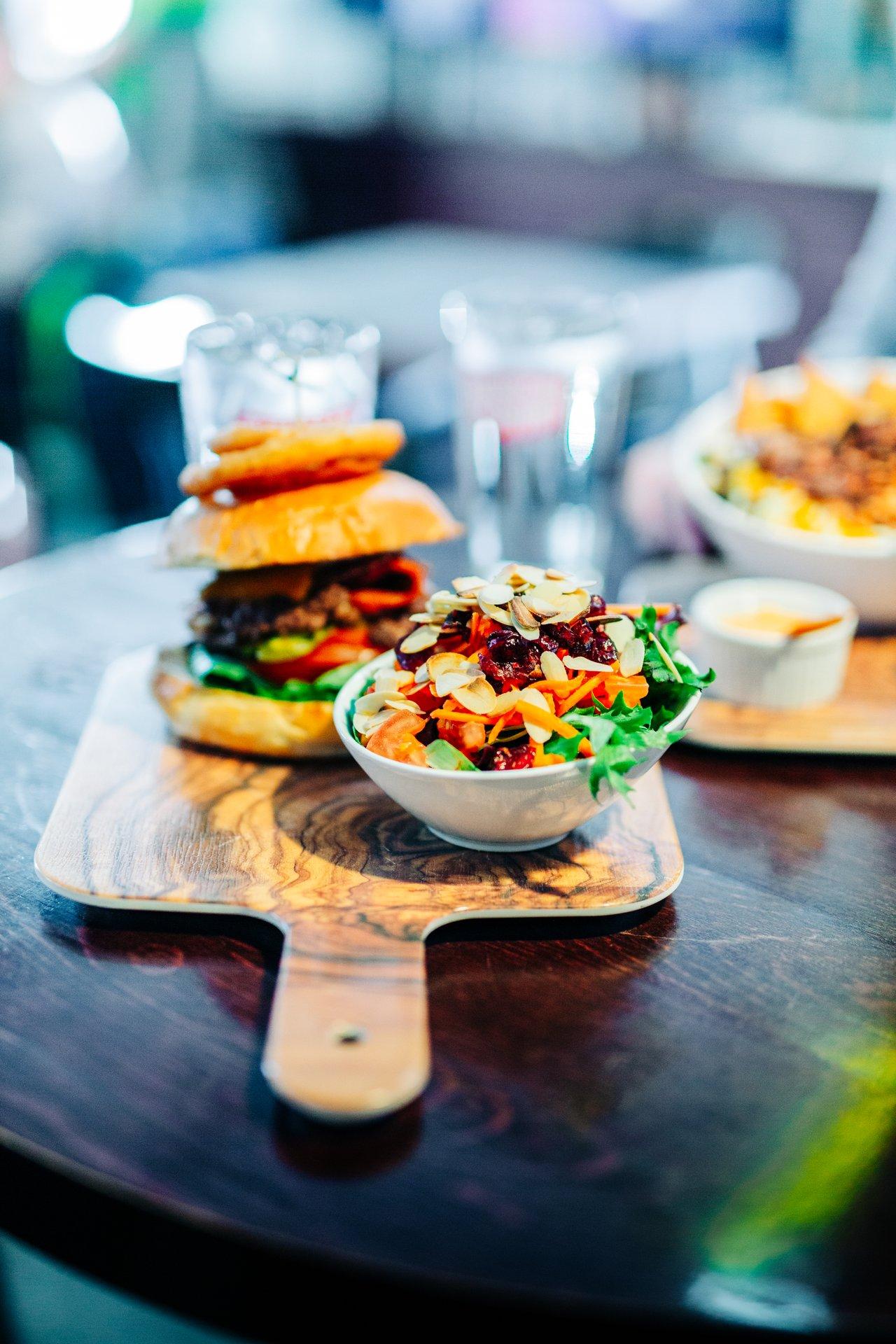 juicy burger and salad at sports bar