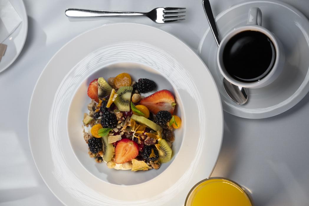 breakfast with coffee and orange juice on table cloth