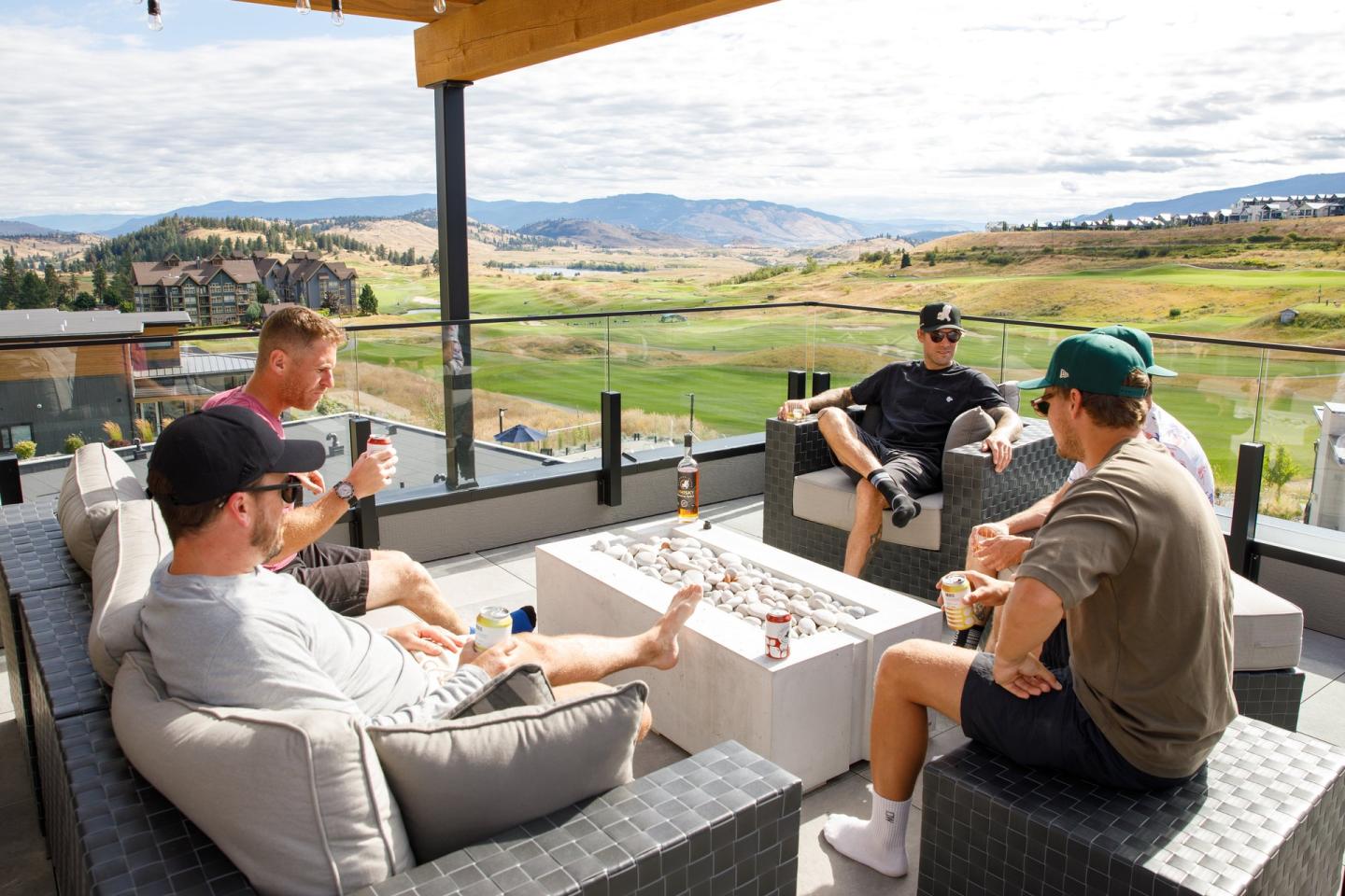 group of friends enjoying patio views at accommodation next to the golf course